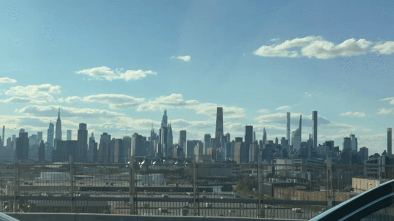 NYC skyline viewed from elevated position amid clear skies