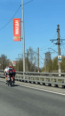 Three cyclists cross bridge in sunny Lisy Nos