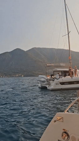 Catamaran anchored in Montenegro bay at golden hour