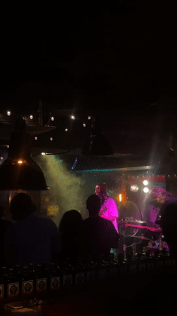 Live band performs at dimly lit bar in Шебунино