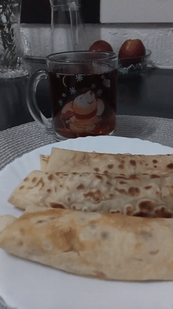 Crepes, dolmades, and flowers on a Chișinău morning table