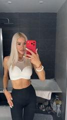 Woman takes bathroom selfie with red phone