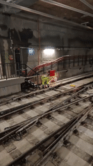 Subway workers conduct track maintenance with sparks flying