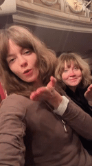 Two women document evening theater outing in winter Moscow