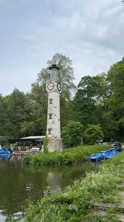 Clock tower lighthouse observed by lake in Pleven Bulgaria