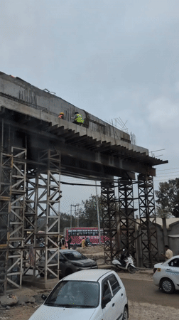 Construction workers building overpass in Jassur, India