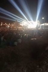 Nighttime community fair with live stage and street stalls in Ngemplik Wetan