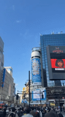 Morning pedestrians navigate Tokyo's famous Shibuya Crossing