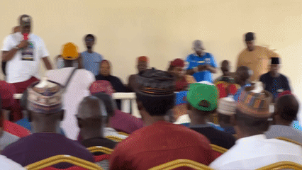 Community speakers address diverse audience in indoor gathering