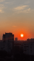 Sunset captured over Krasnoyarsk cityscape with traffic below