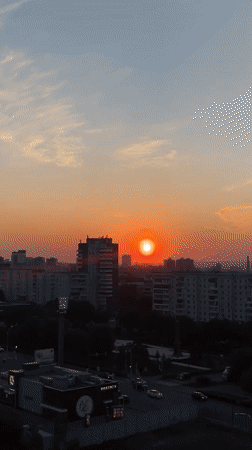 Sunset captured over Krasnoyarsk cityscape with traffic below