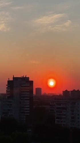 Sunset captured over Krasnoyarsk cityscape with traffic below