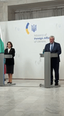 Two people at podiums in official meeting setting