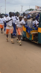 Traditional festival procession with decorated rickshaws in Maigizo, Nigeria