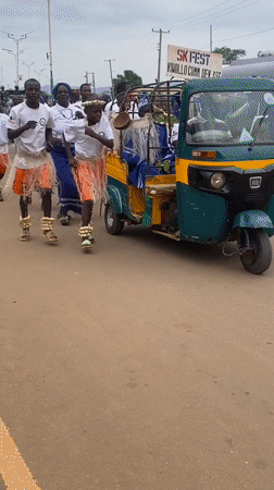 Traditional festival procession with decorated rickshaws in Maigizo, Nigeria