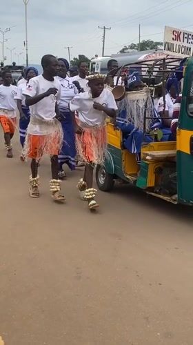 Traditional festival procession with decorated rickshaws in Maigizo, Nigeria