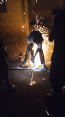 Metal workers cutting and welding in Kuru Dungus evening