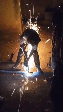 Metal workers cutting and welding in Kuru Dungus evening