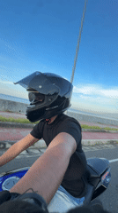 Motorcyclist rides through Davao City at sunset