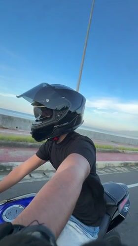 Motorcyclist rides through Davao City at sunset
