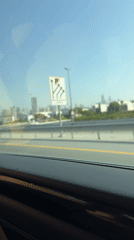 Early morning highway drive captures Dubai skyline view