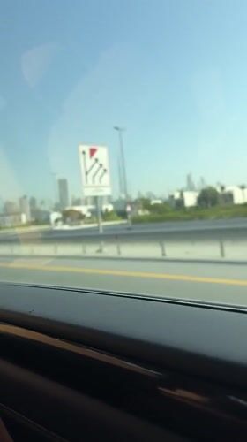 Early morning highway drive captures Dubai skyline view