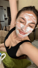 Woman documents morning skincare routine with facial mask in Sochi