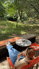 Woman relaxes with pet Chihuahua on Podgorica patio