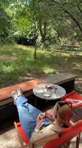 Woman relaxes with pet Chihuahua on Podgorica patio