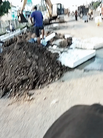 Road construction crew operates excavator in Kebakkramat, Indonesia