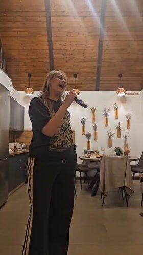Woman singing in residential home interior, Ufa Russia