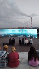 Kemerovo riverfront: miner statues, smokestack skyline, public square