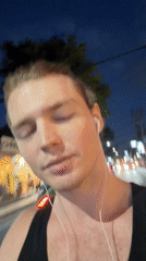 Man films himself making gestures on Kuta street