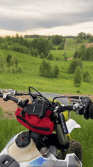 Dirt biker pauses for photos in Russian countryside