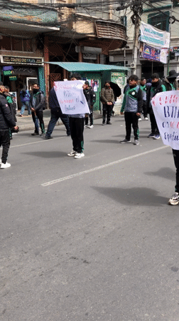 Youth demonstrate in matching tracksuits on La Paz streets
