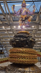 Multi-armed deity statue display captured at Thai airport