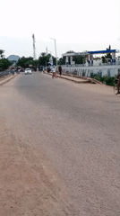Street traffic moving past a gas station in Mubi, Nigeria