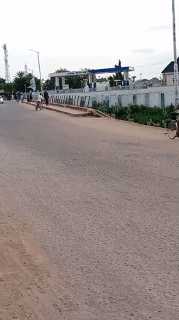 Street traffic moving past a gas station in Mubi, Nigeria