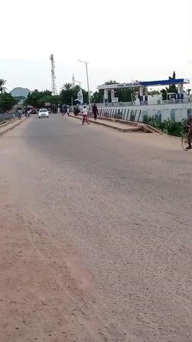 Street traffic moving past a gas station in Mubi, Nigeria
