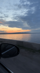 Sunset drive along waterfront road captured in Chaikovsky, Russia