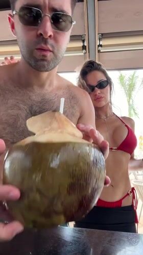 Couple enjoys coconut drinks at Thai beach resort
