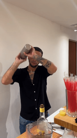 Bartender mixes cocktails at late-night venue in Búzios, Brazil