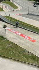 Two men deploy banner on walkway in Krasnaya Polyana