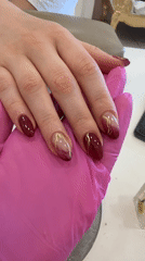 Woman gets dark red manicure in Sofia