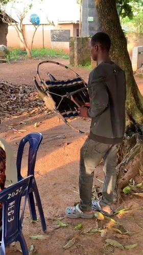 Drumming and dancing at an outdoor gathering in Akwanga