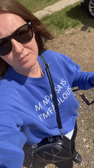 Woman takes selfie, relaxes on grass in Noviy