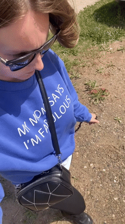 Woman takes selfie, relaxes on grass in Noviy