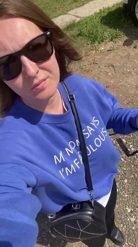 Woman takes selfie, relaxes on grass in Noviy