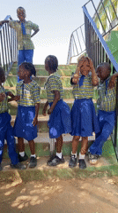 School children gather in uniforms on stairs in Nigeria