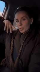 Woman passenger with braids recorded in car in Klin